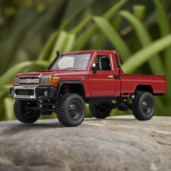 MN82 Toyota Land Cruiser 4WD RTR 1/12 Truck Crawler Left view sitting on a rock with folage in the back drop